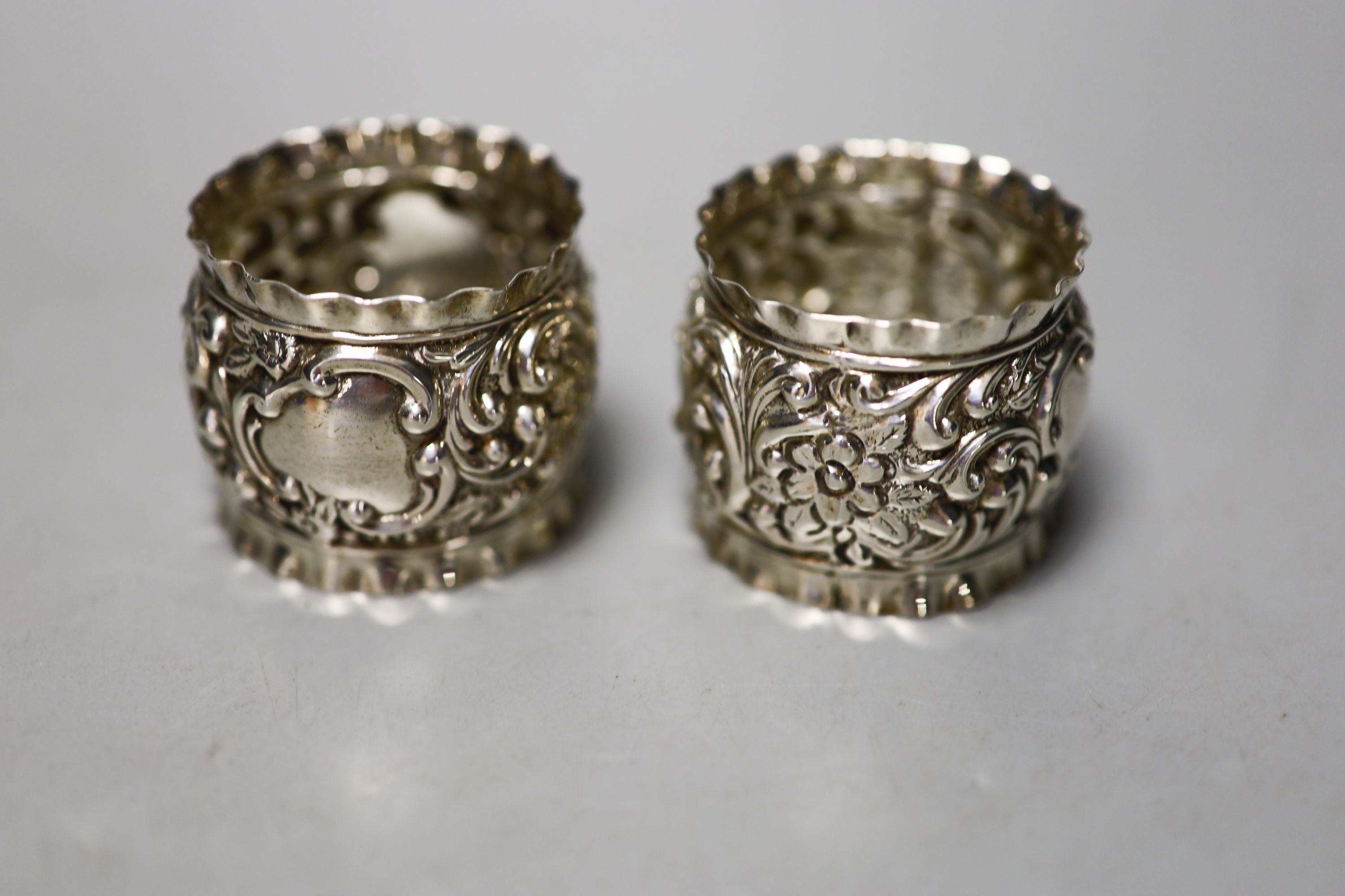 Four pairs of silver napkin rings including cased Victorian and a cased pair of silver pepperettes.